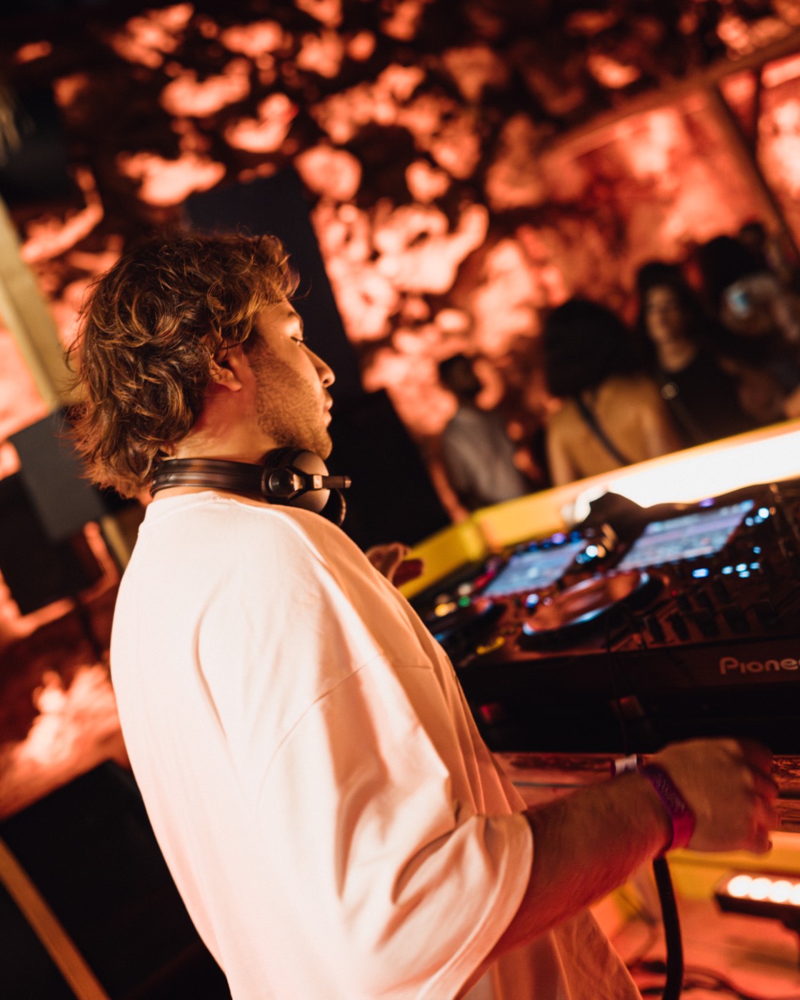 A DEEN mixing in a white t-shirt