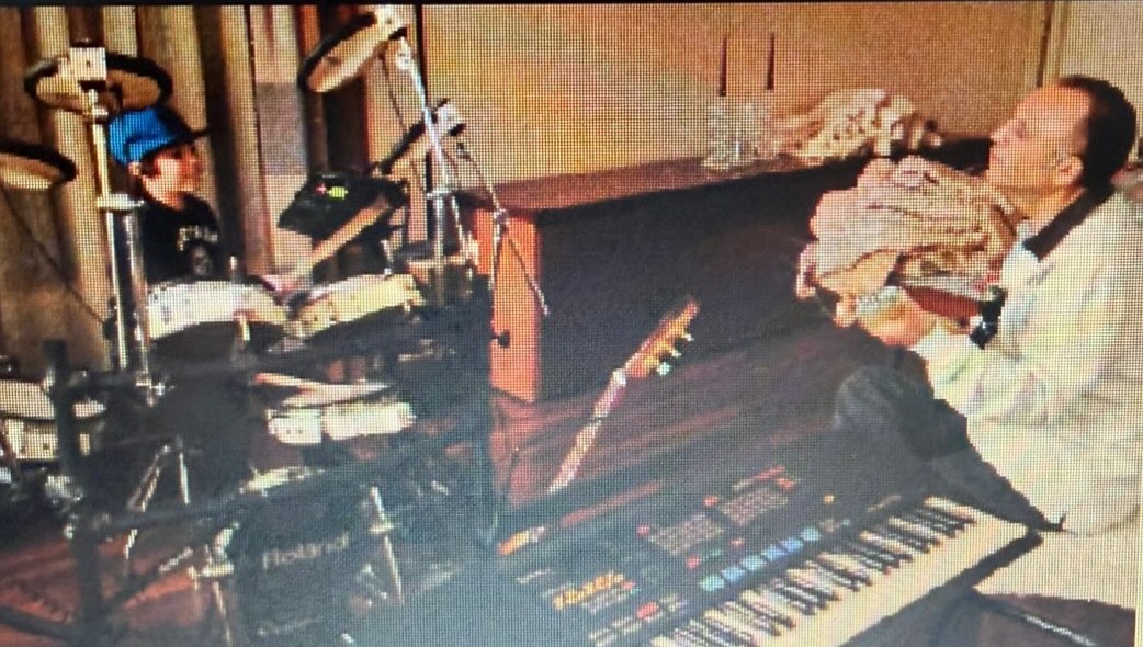 A DEEN as a kid on the drums, his father beside him with a guitar